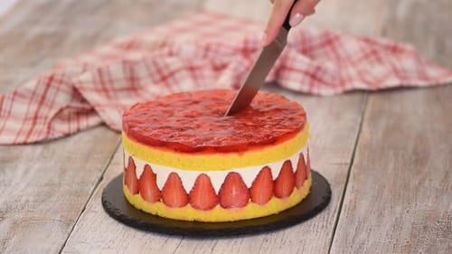 Knife Slicing Delectable Strawberry Cream Cake Dessert