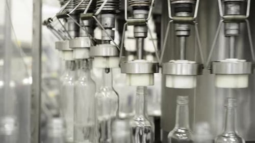 Bottles Moving on Conveyor Belt in Factory