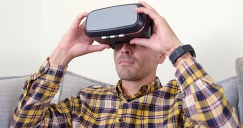 Man Using Virtual Reality Headset at Home