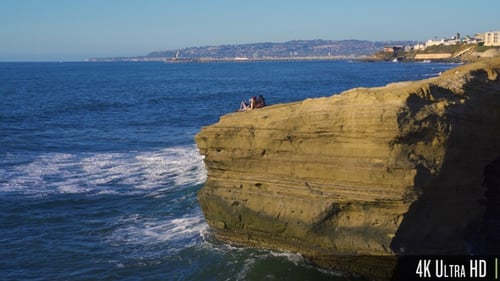 4K Relaxing Couple on Steep Waterfront Cliff Waiting for the Sunset in San Diego, CA