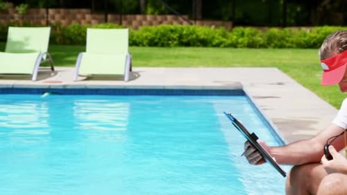 Lifeguard Inspects Poolside With Clipboard and Timer