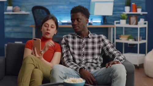Couple Video Chatting on Smartphone in Living Room