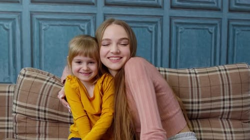 Woman and Child Smiling on Couch Together