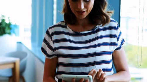 Female executive using digital tablet in office