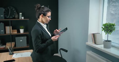 Attractive Lady Using Digital Tablet at Office