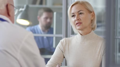 Woman Discusses Medical Issue With Doctor In Office