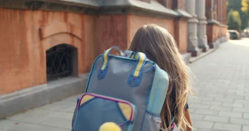 Follow Up Shot of Little Girl Running Into School Building