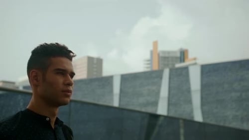 Young Man Walking in an Urban Environment