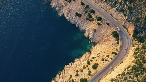 View of the Country Road with Driving Cars and Blue Sea From Above