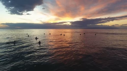 Sunset And Surfers Waiting For The Waves