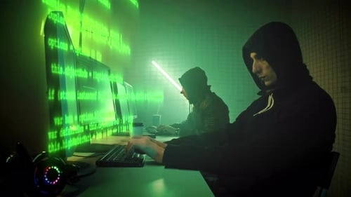 Hooded Coders Working in a Cyberpunk Setting