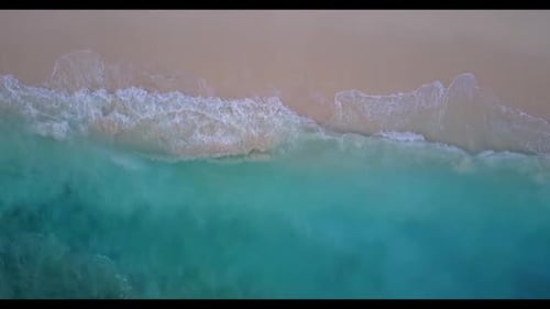Aerial flying over tourism of marine coast beach lifestyle by shallow water with bright sandy backgr
