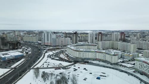Suburb of a big city. City block from the height of the flight. City highway with busy traffic.