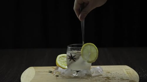 Iced Lemonade Being Stirred with Spices