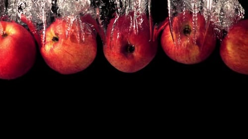 Red Apples Dropping Into Clear Water