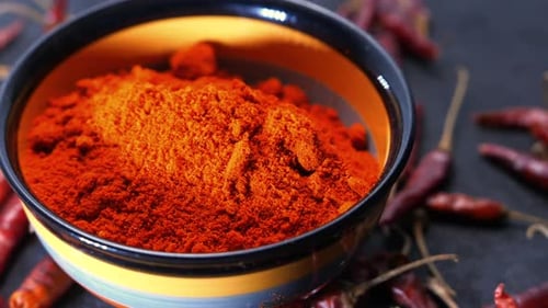 Bowl of Bright Chili Powder and Dried Peppers