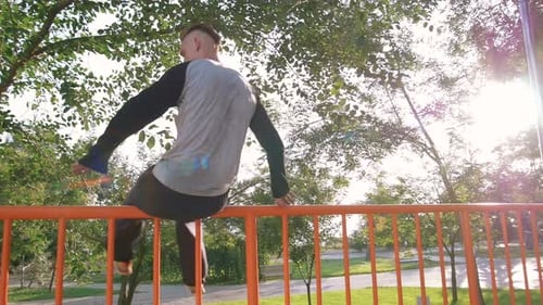 Young Man Doing Parkour Tricks in Extreme Sports Park