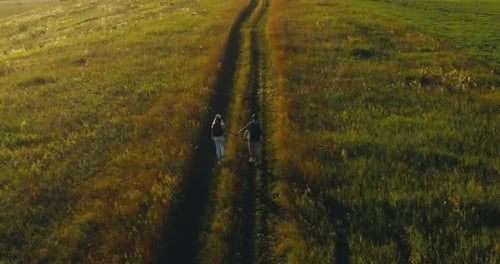 Travelers Walk Through the Fields and Meadows Together Hiking