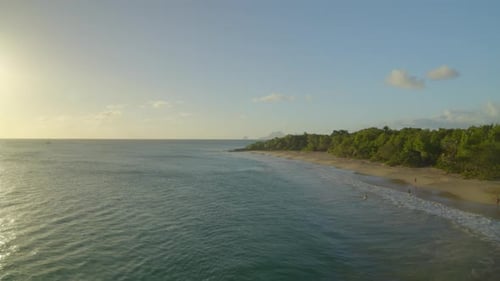 Tourist on seashore at sunset, Caribbean