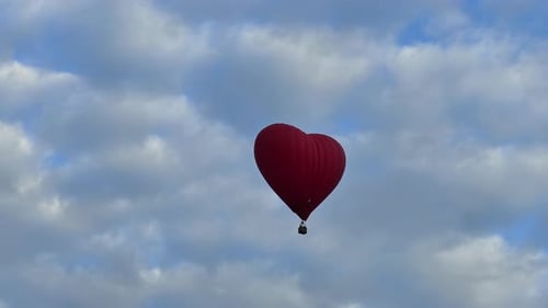 Heart Shaped Hot Air Balloon in Cloudy Sky