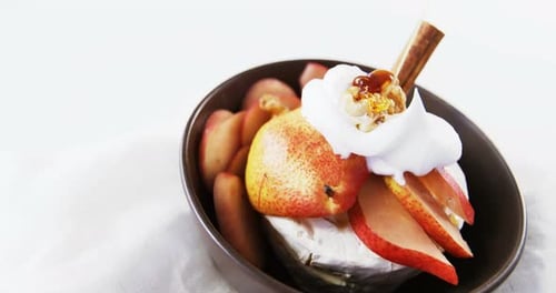 Cheese dessert with sliced fruits and sauce