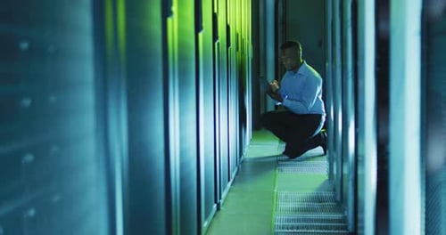 Technician Using Tablet in Modern Server Room