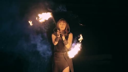 Woman Performs Fire Dance at Night with Staff