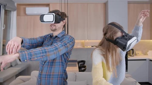 Couple Exploring Virtual Reality Together in Home