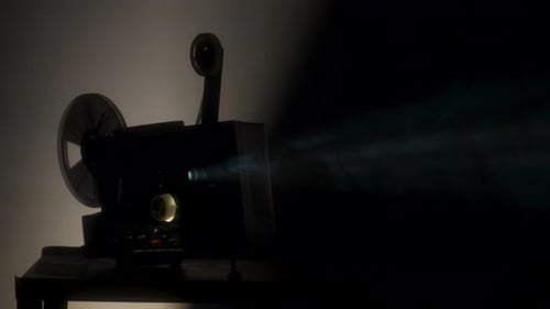 Vintage 8mm Film Projector Broadcasting in Dark Room