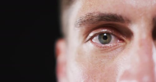 Close up portrait of face of caucasian man with focus on blinking eye