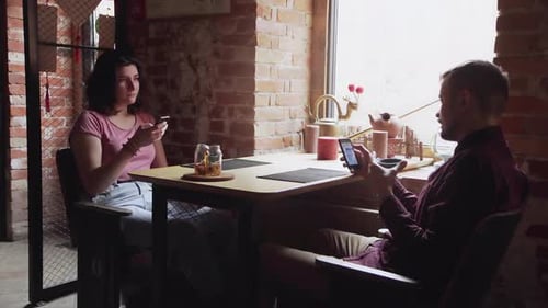Dating Couple Relaxing Together in Chinese Tea Cafe