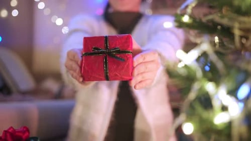 close-up asian female hand present sending present gift box