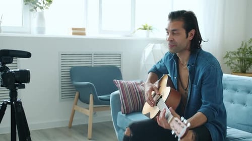 Man With Guitar Recording Music Video Indoors