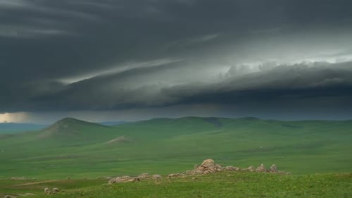 Scenic Green Hills Underneath Dramatic Sky