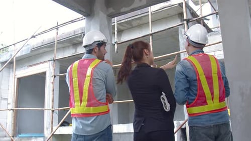 Confident Construction Team Stands in Unfinished Building