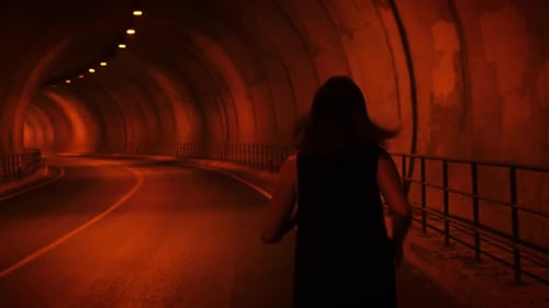 Woman running in tunnel