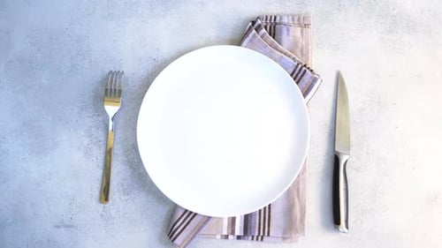 Simple Table Setting with White Plate and Cutlery