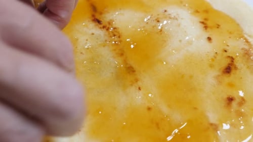 Slow tilt jam of peaches on pancake texture close-up 4K 2160p 30fps UltraHD footage - Apricot marmal