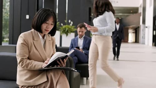 Modern Office Lobby with People Working and Waiting