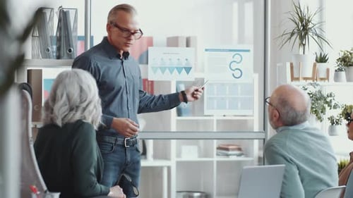 Professional Man Presenting Business Data in Modern Office