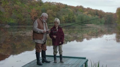 Grandfather Fishing with Grandson From Wooden Pier