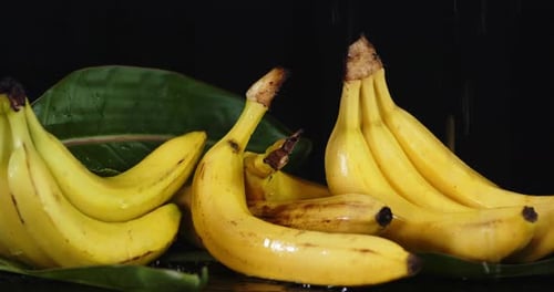Bananas and Green Leaf with Gentle Water Pouring