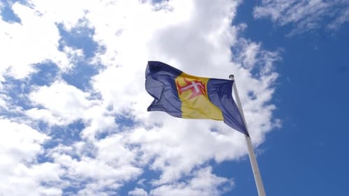 Flag Waving Against Blue Sky Background