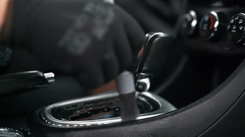 Working cleaner at car wash. Cleaning the transmission box using a brush and chemical solution. Slow