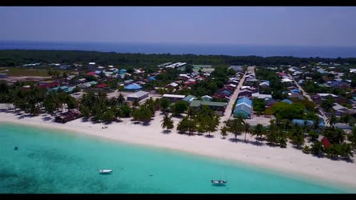 Aerial drone shot panorama of tranquil shore beach break by turquoise ocean with white sandy backgro