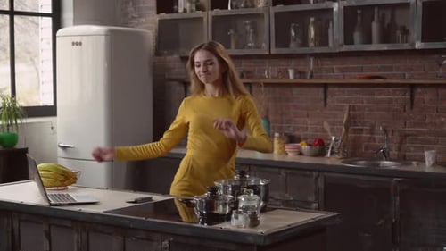 Woman Dancing Happily in Kitchen at Home