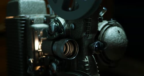 Moody close up of an old 8mm projector, shallow depth of field and high contrast.