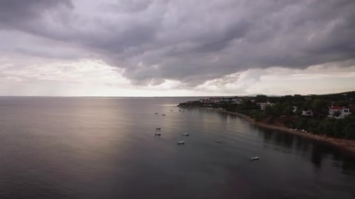 Coastal Resort, Sea and Grey Clouds in the Sky, Aerial. Trikorfo Beach, Greece