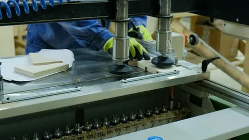 A Carpenter at a Furniture Factory Will Make Holes on a Modern Drilling Machine
