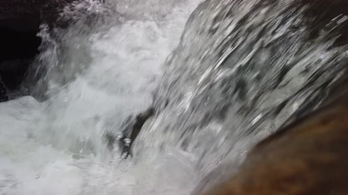 Flowing clear river water stream. Rapid river with water fall